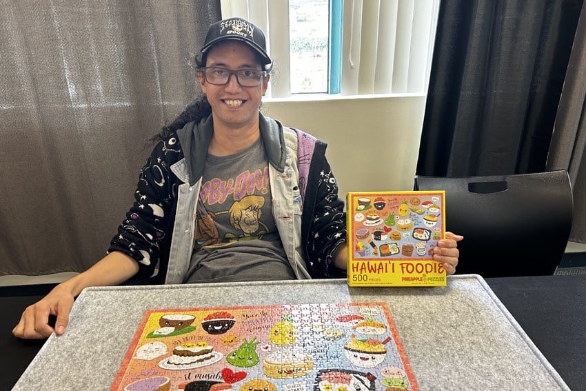 Photo: Abraham with a completed jigsaw puzzle