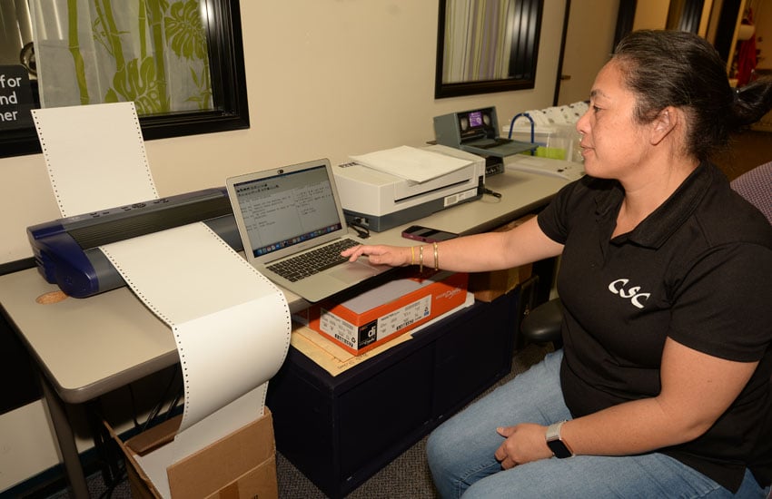 Photo: Staff member using a braille printer