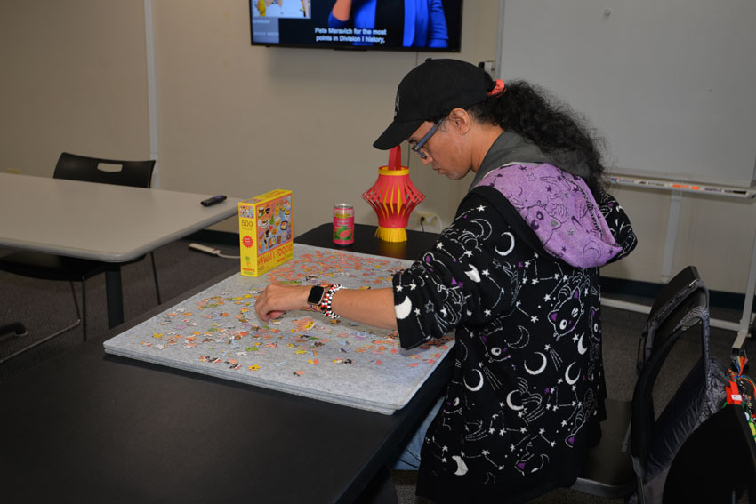 Photo:  Abraham working on a jigsaw puzzle