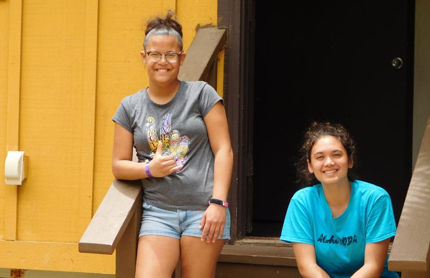 Photo: Camp Participants sitting outside a bungalow