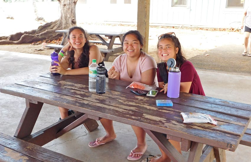 Photo: Camp participants sitting at a picnic table