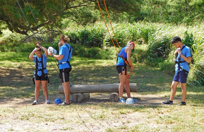 Photo: Camp participants get strapped in climbing harnesses